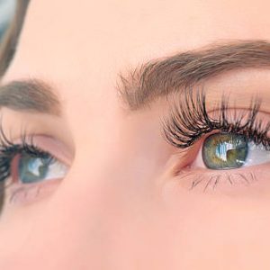 side view of woman green eyes looking away, long eyelashes.horizontal shot.