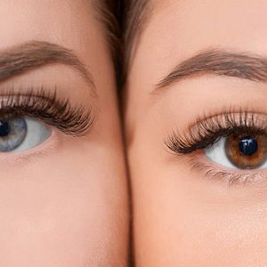 front view of human eyes looking at camera.blue and hazel colors.false eyelashes.