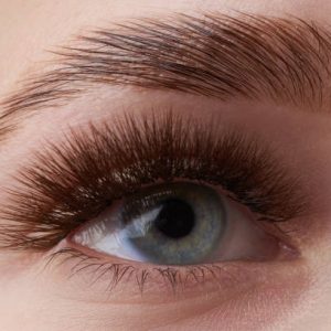 Beautiful macro photography of a woman's eye with extreme make-up of long eyelashes. Perfect long eyelashes. without cosmetics. Close-up fashion eye visage, lamination eyebrow beautiful